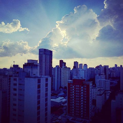 eye level view of a cityscape during the sun breaking through clouds