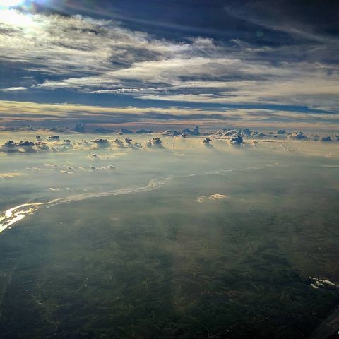 Landscape seen from up in the clouds of hazy greenery